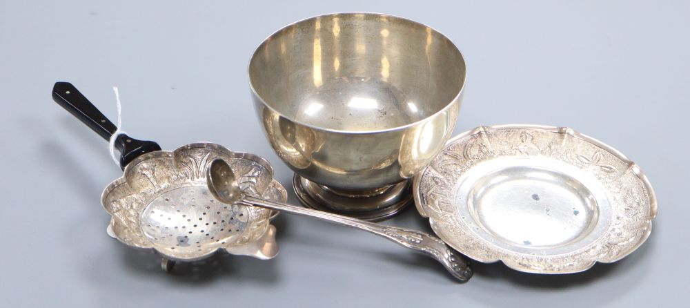 A George V plain silver sugar bowl, diameter 10.5cm, 4oz., a Victorian condiments spoon and an Indian white metal tea strainer and stan